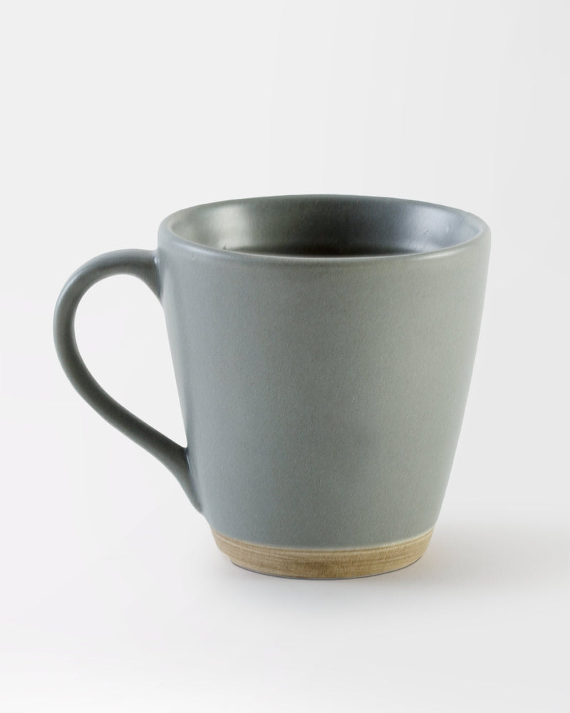 Basalt Mug in matte grey with a curved handle and natural clay base.