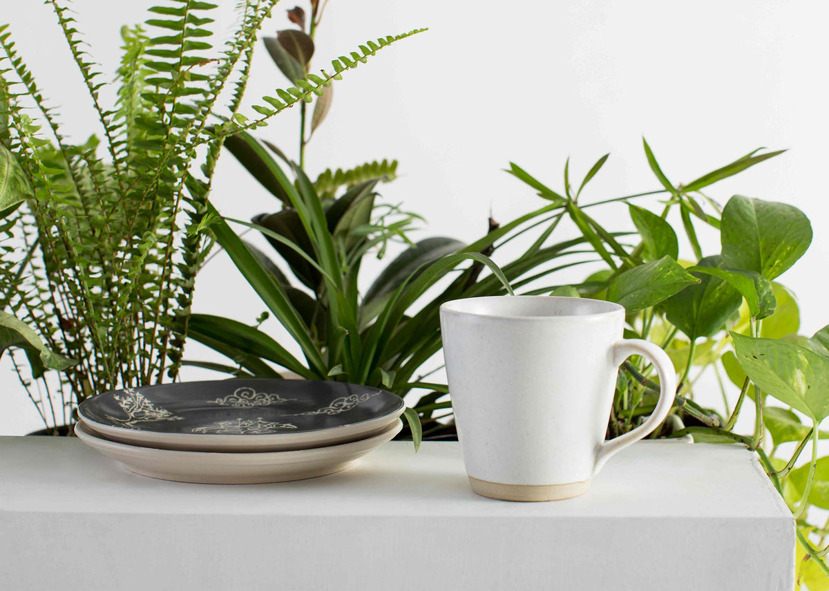 Sandstone Mug with a cream glaze and tan base, seen from the front.