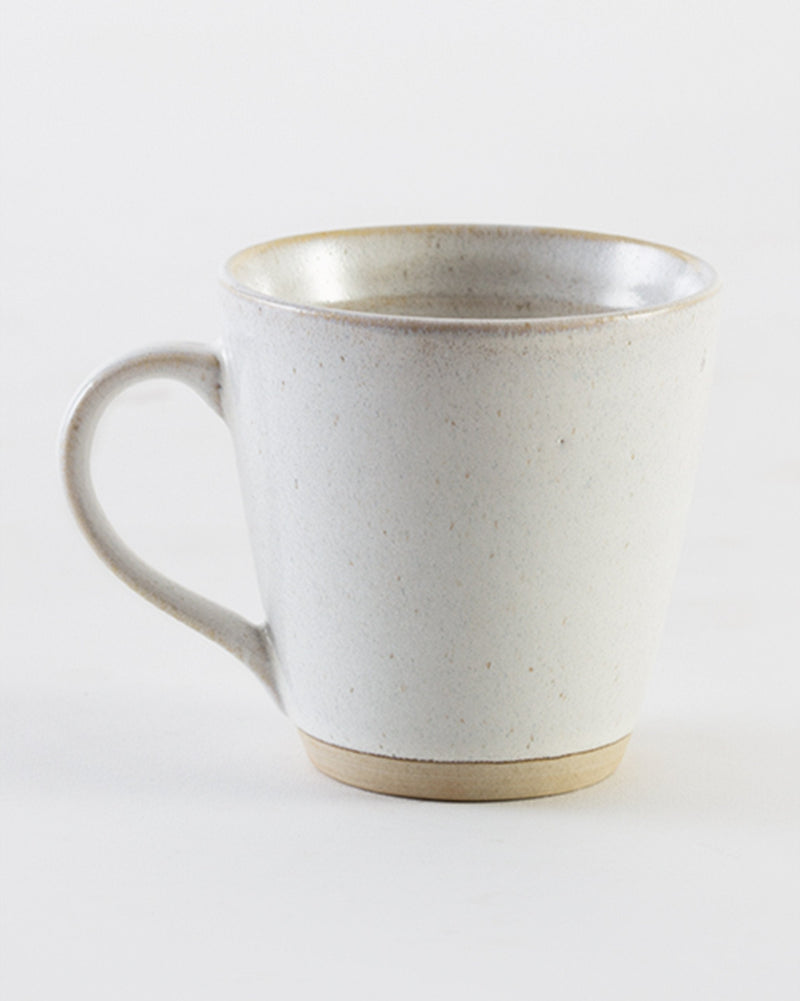 Side view of Sandstone Mug with a cream glaze and tan base.