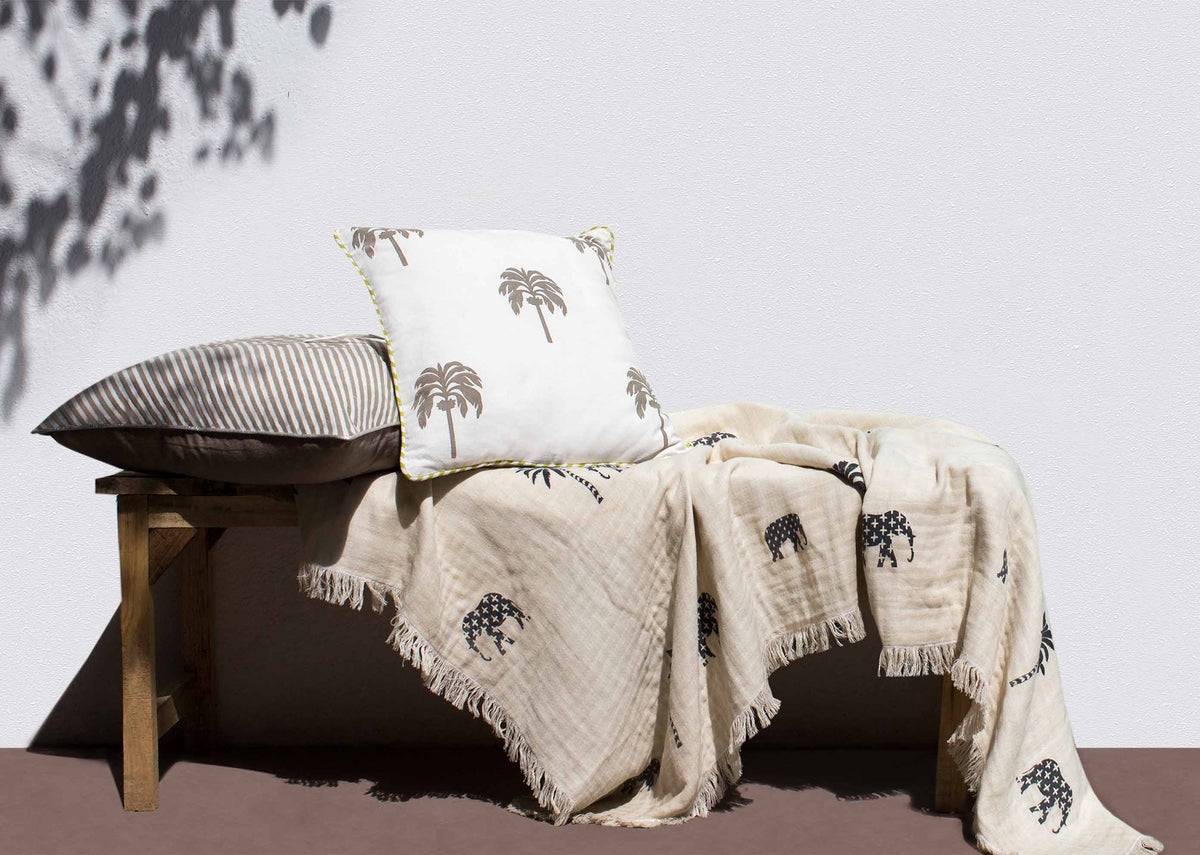 Colombo Palm Block Cushion Cover in soft grey, styled with other cushions.