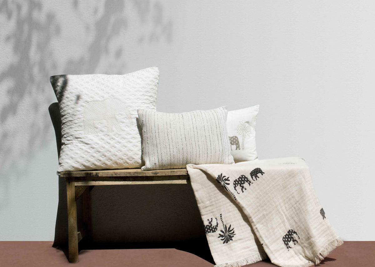 Colombo Classic Textured Pillow Cover in cream with silver stripes, beside other cushions.