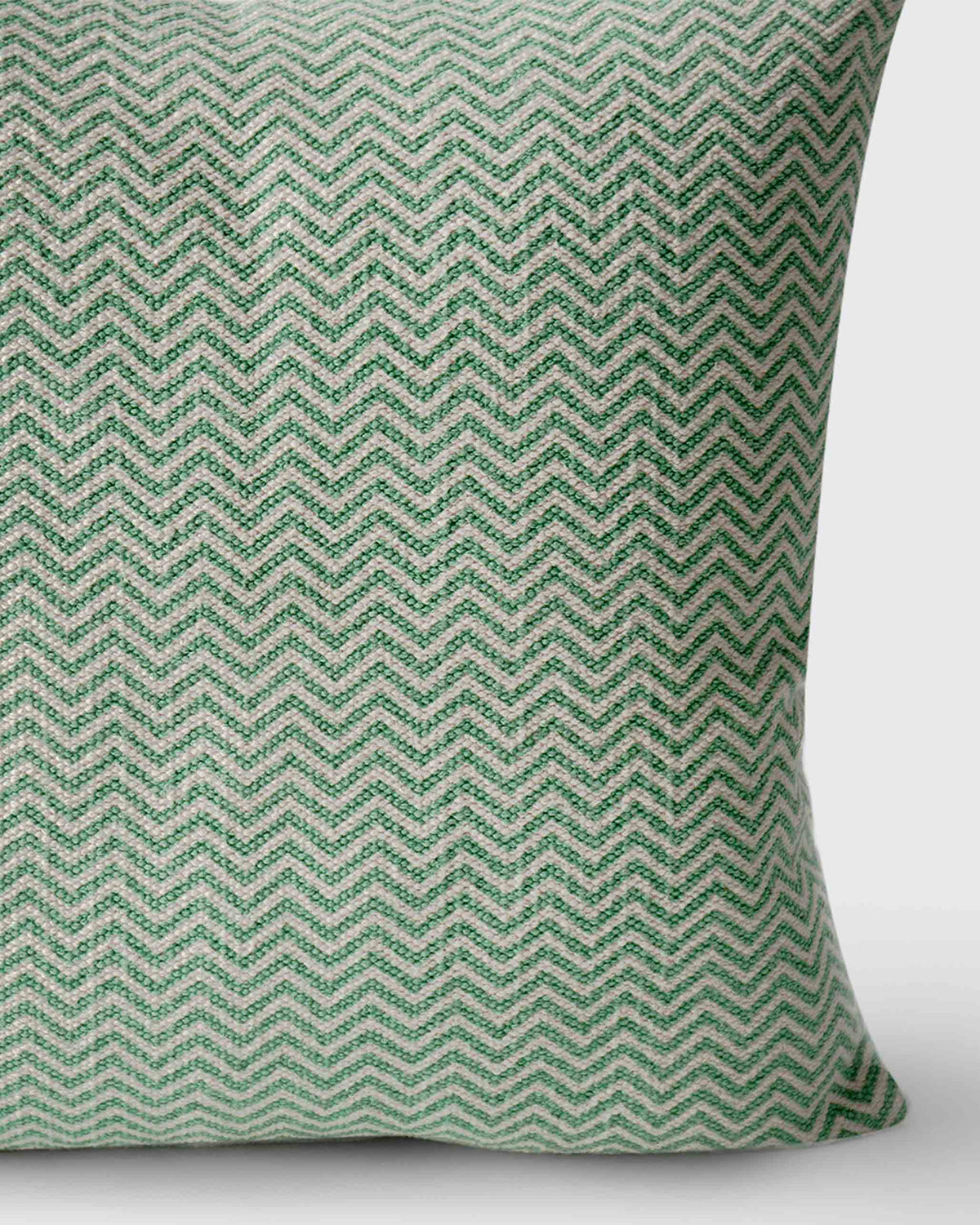 Close-up of the Mahe Chevron Cushion Cover showing its green and cream chevron weave.