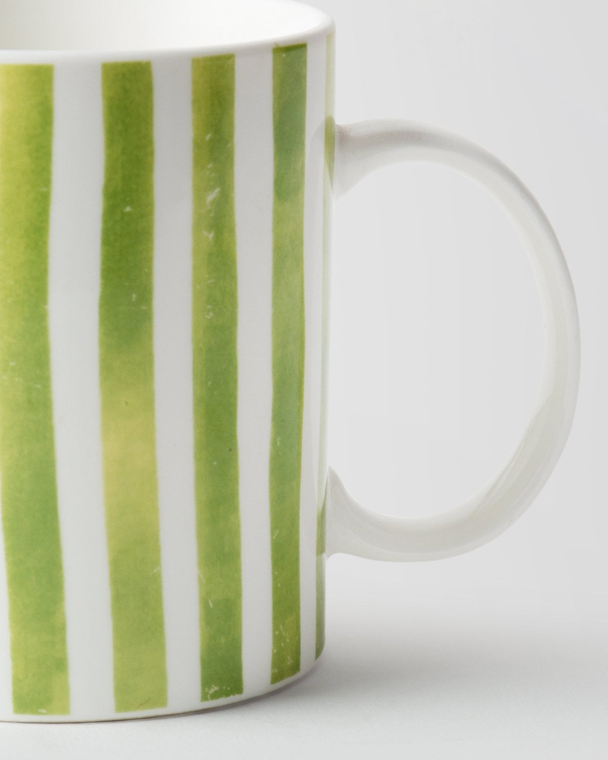 Close-up of Flora Fauna Stripes Mug showing its handle and green stripes.