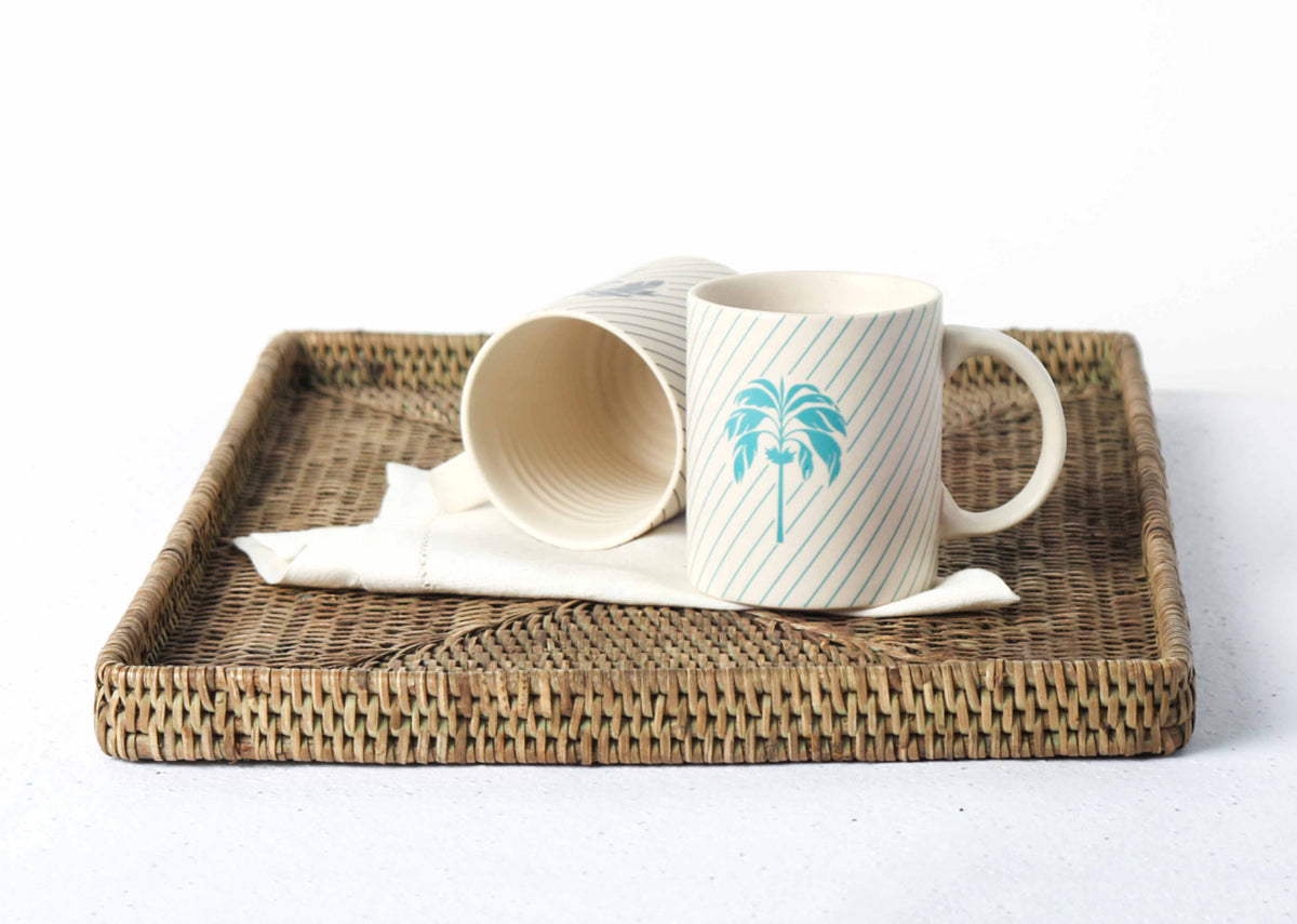 Pair of Palm Mugs with aqua palm trees, one turned away.