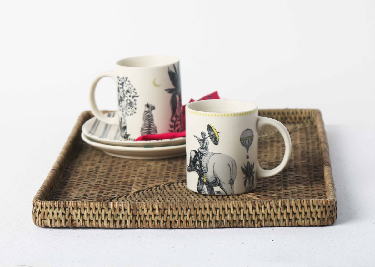 Hathi Mug on a woven tray beside a patterned mug.