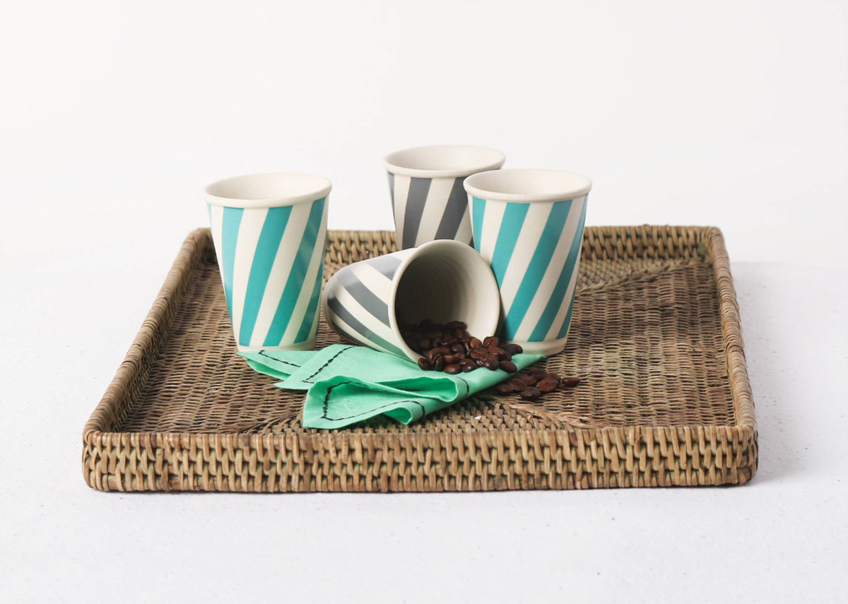 Set of four Lotus Aqua Candy Stripe Kulhar cups on a rattan tray.