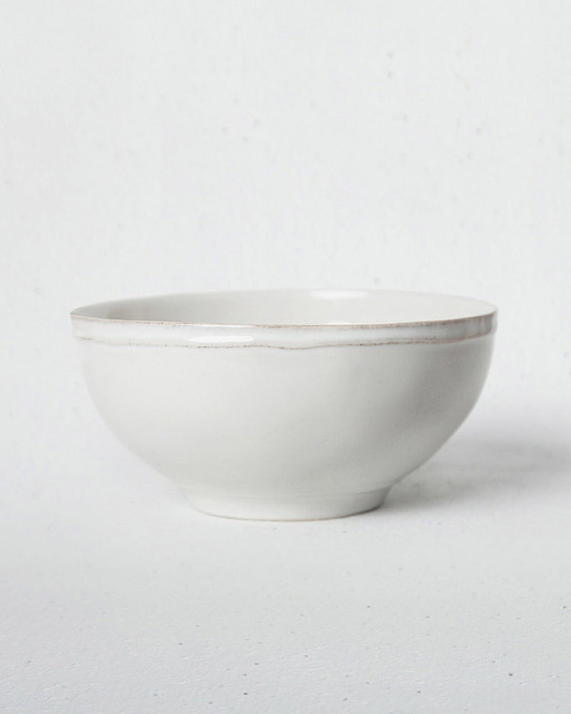 Side view of the Aguada Cereal Bowl in white, showing its rounded profile.