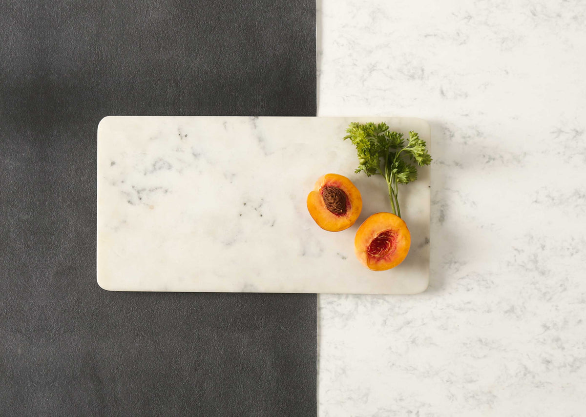 Marble Cheese Board with halved apricots and a sprig of parsley.