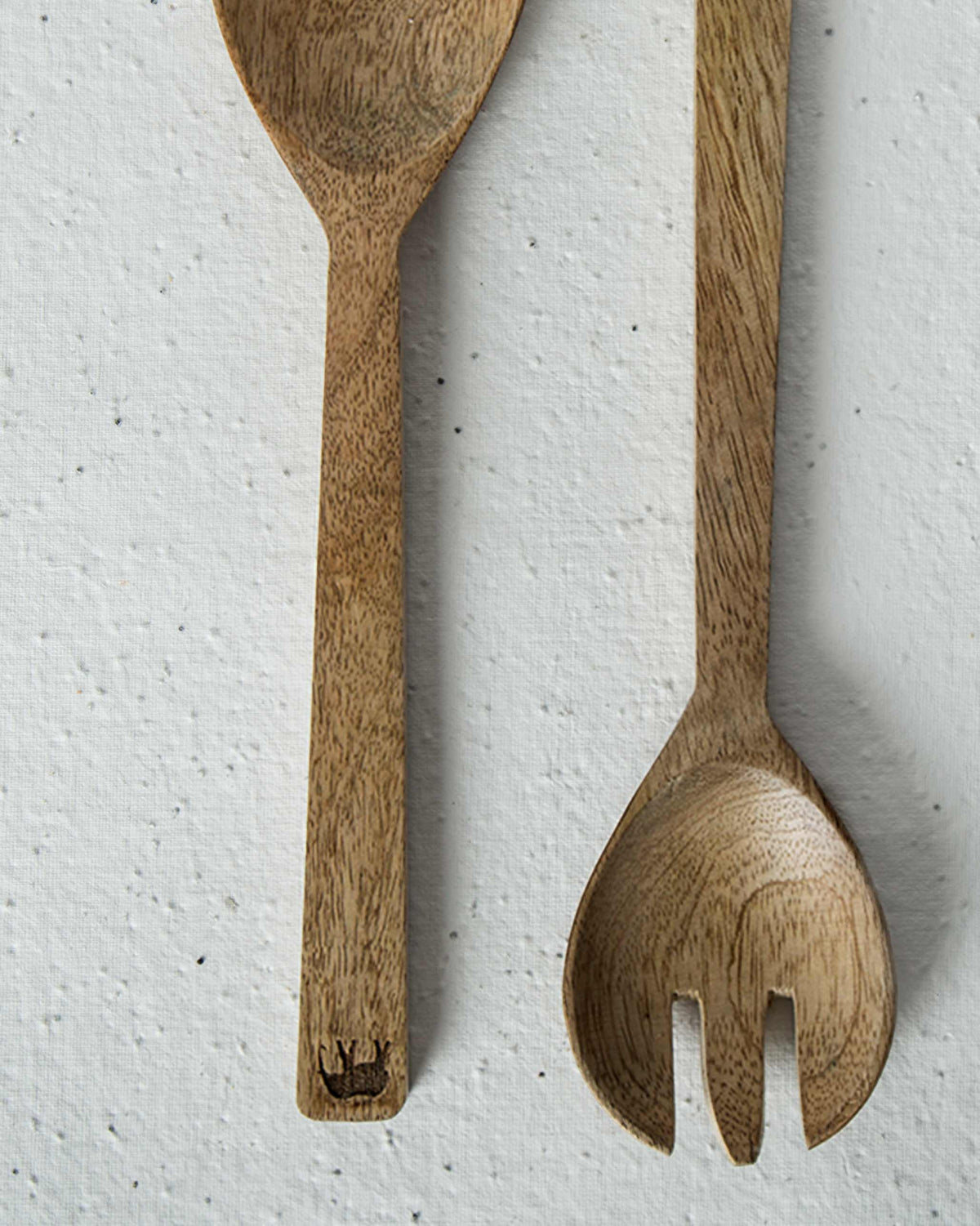 Close-up of Ele Palm Salad Servers showing a small motif at the handle end.