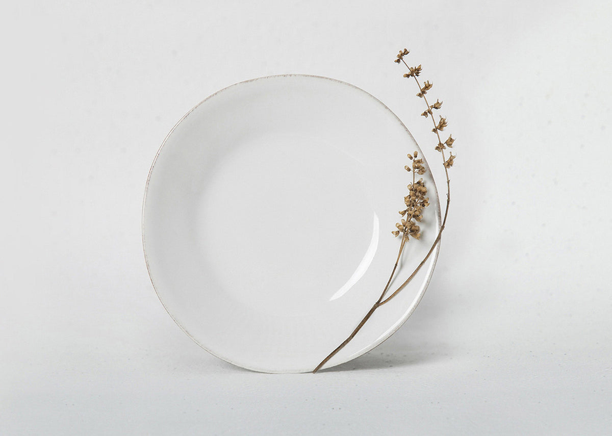 Aguada Tapas Plate in glossy white glaze, shown at an angle.