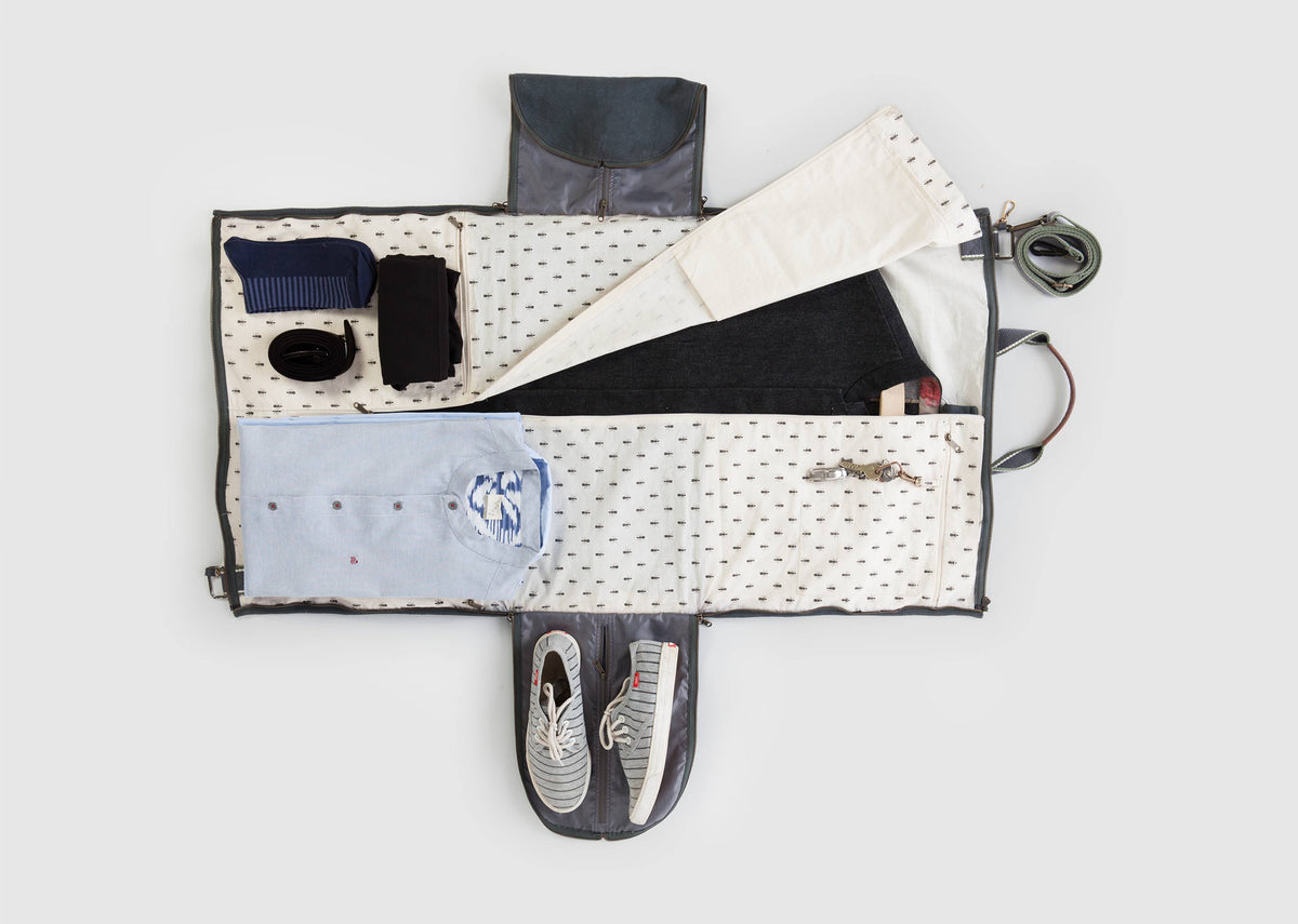 Coat Hanger Bag laid open with clothes and shoes packed inside.