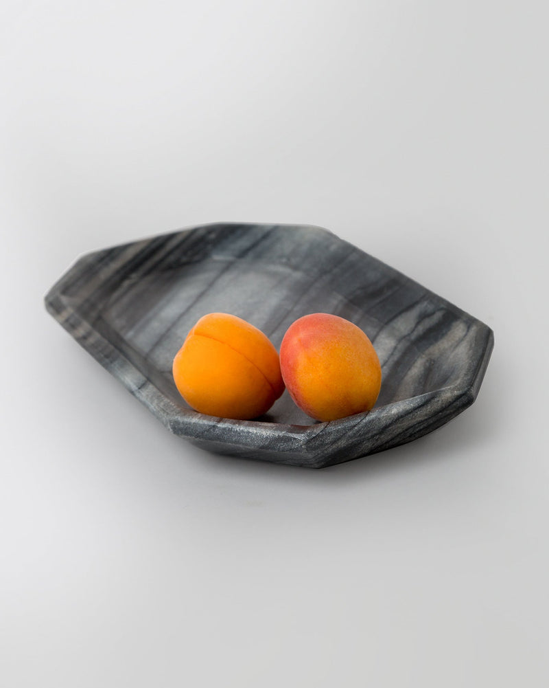 Angled view of the black Bagua Tray with faceted edges.