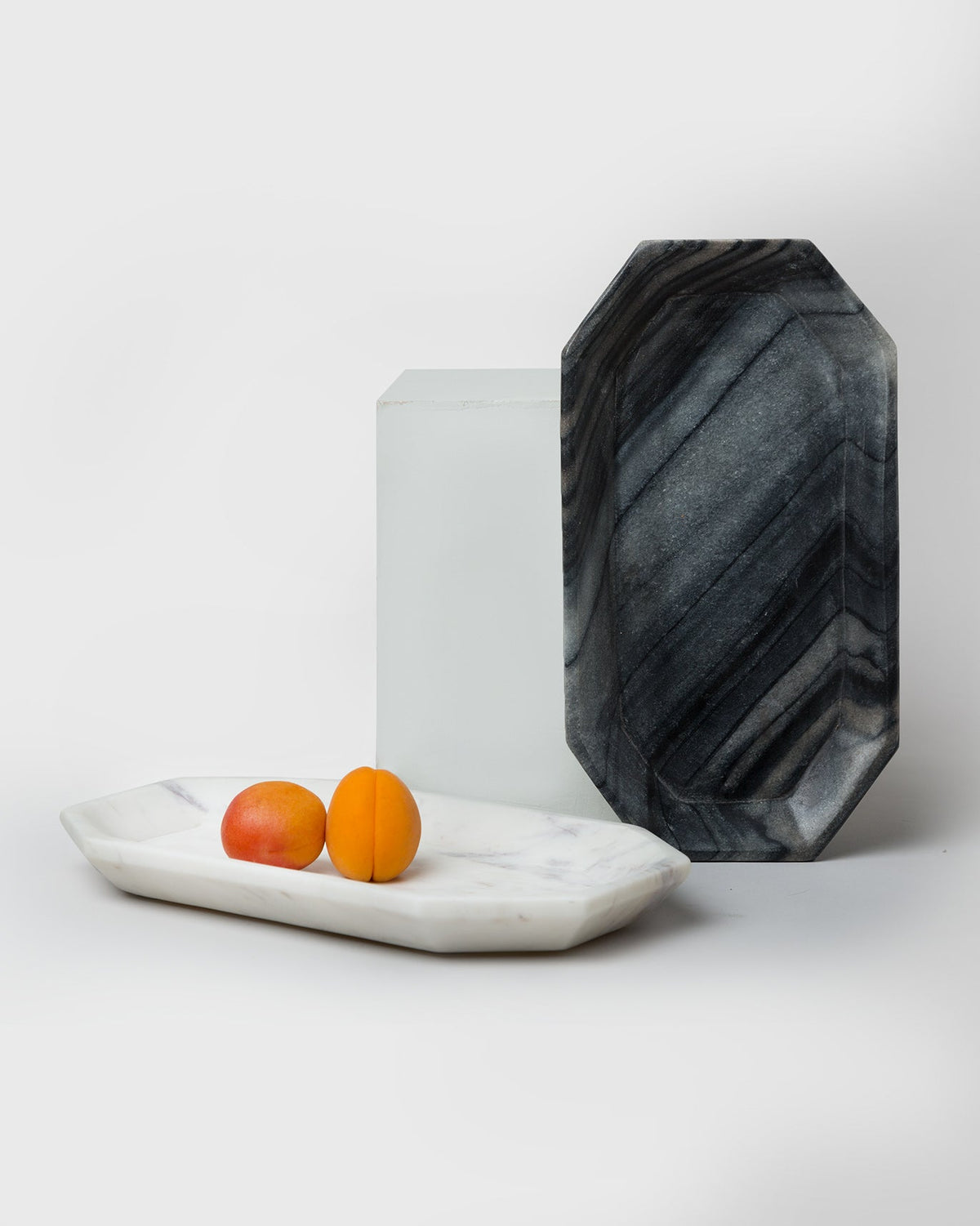 Black Bagua Tray propped up beside a white tray.
