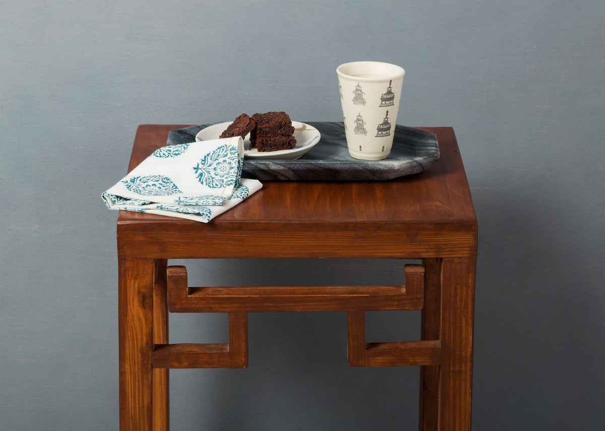 Black Bagua Tray placed on a wooden stool.