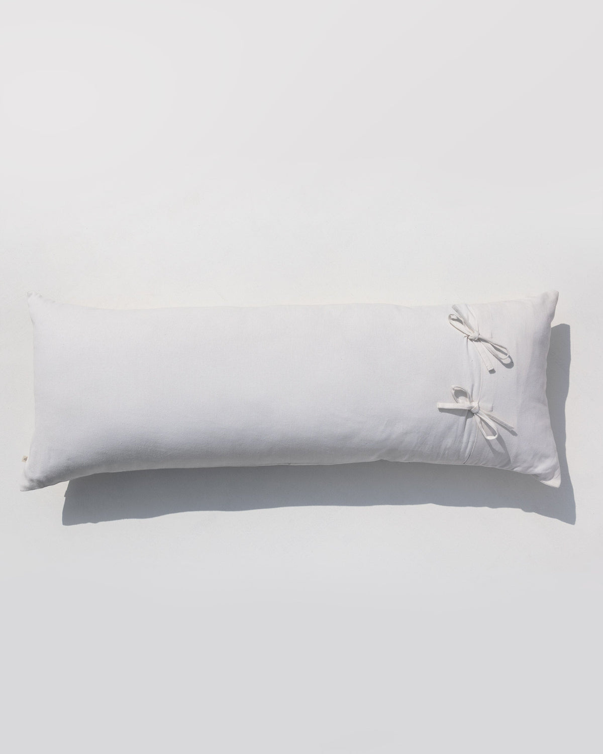 Back of Ele Palm Pillow Cover with white ties on one end.