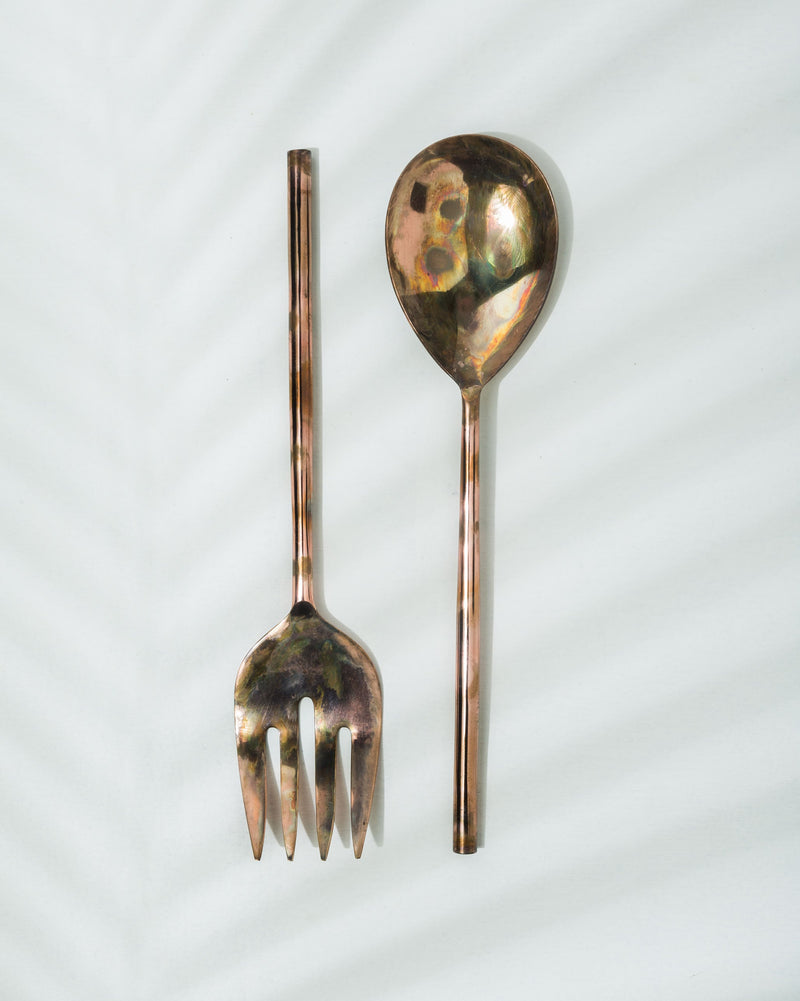 Pair of Bentota Salad Servers laid flat, a spoon and a fork side by side.