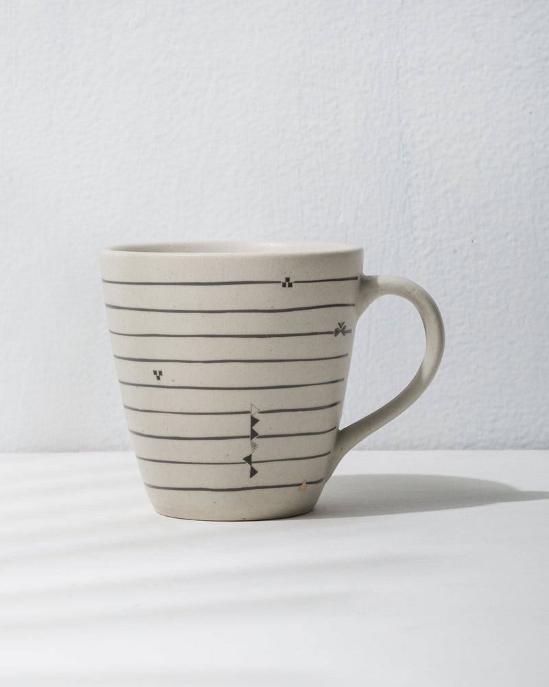 Ceylon conical mug with grey horizontal lines and small dot motifs.