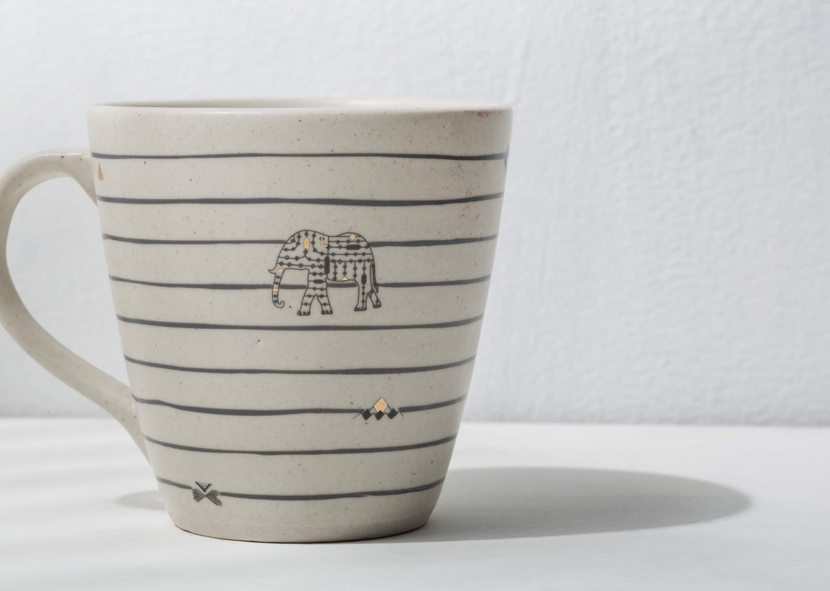 Side view of the Ceylon conical mug with an elephant motif.