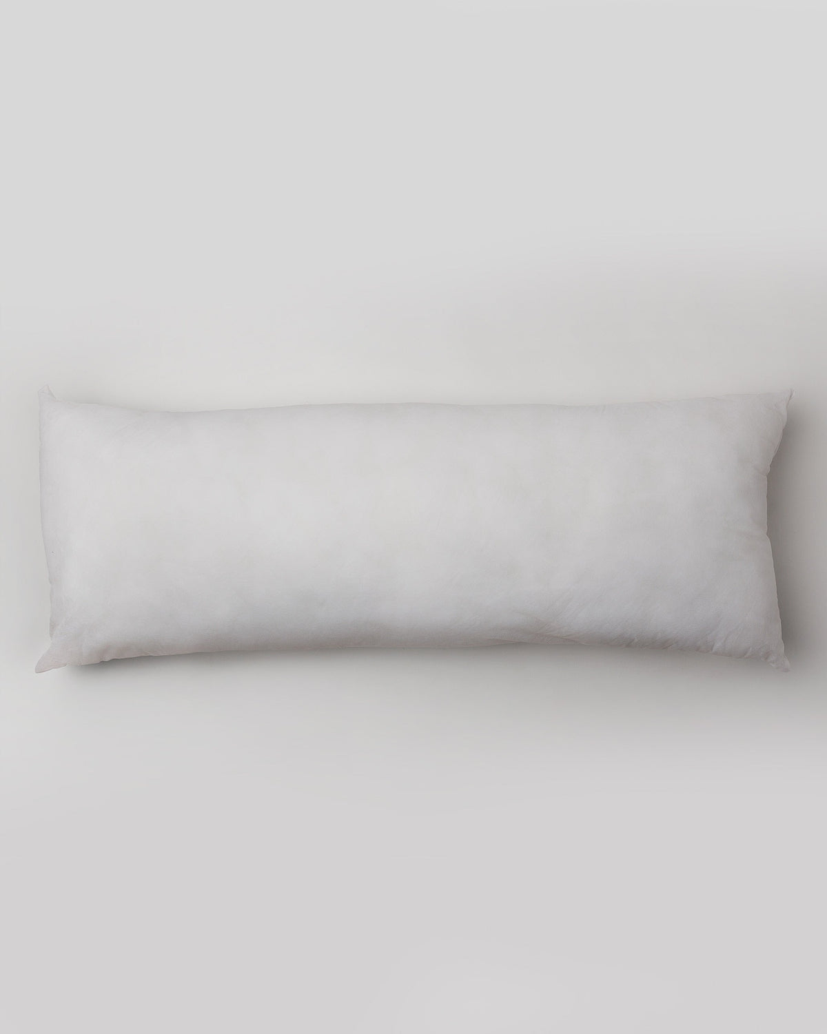 Overhead view of a long white Pillow Filler 36 x 91 cm.
