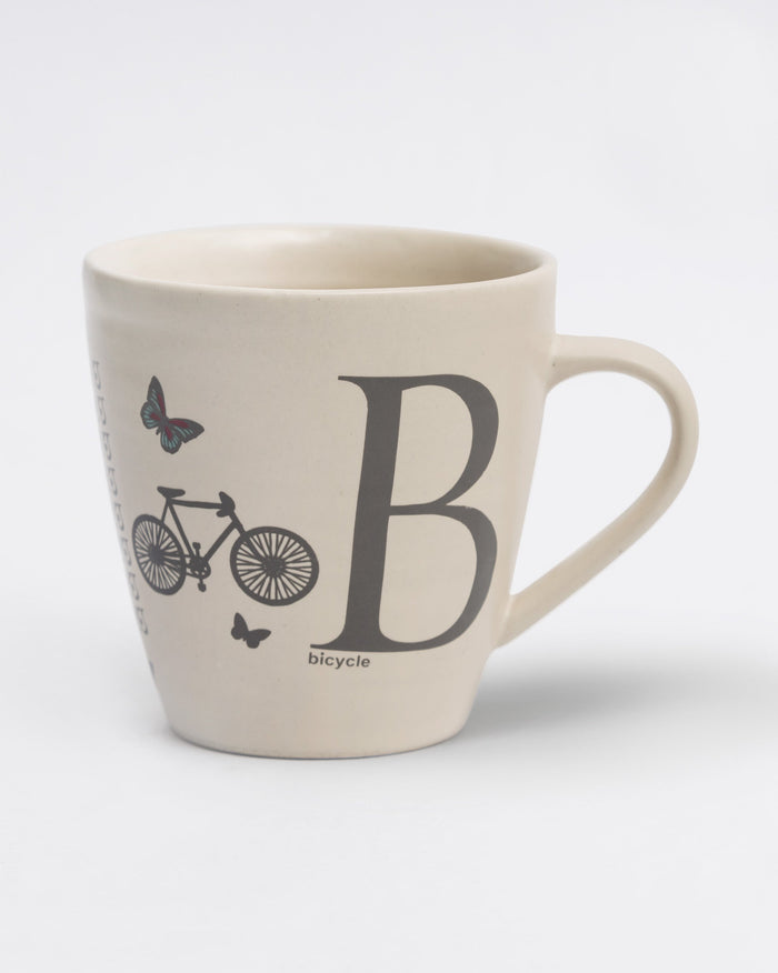 Alphabet B Mug in stoneware with a bicycle and butterflies beside a large B.