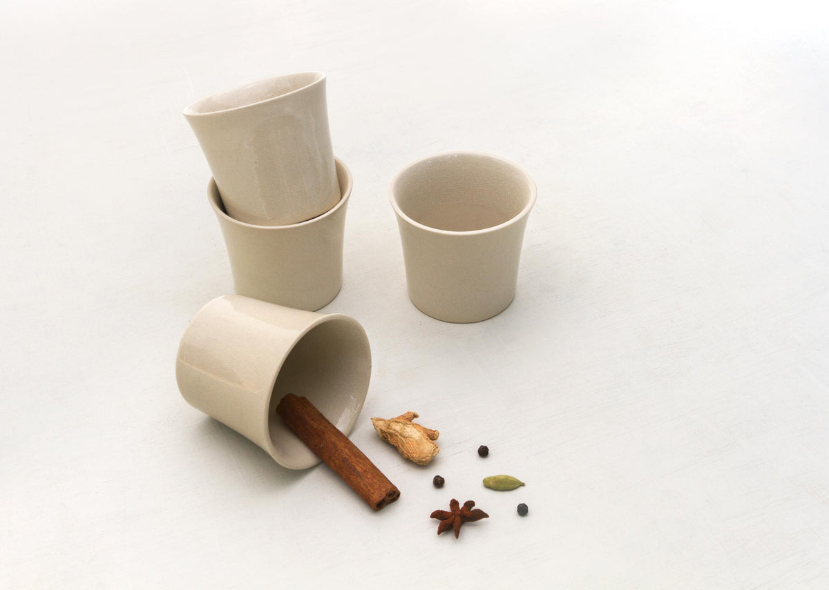 Colombo Teacup (Set of 4) in beige, with one cup tipped on its side.