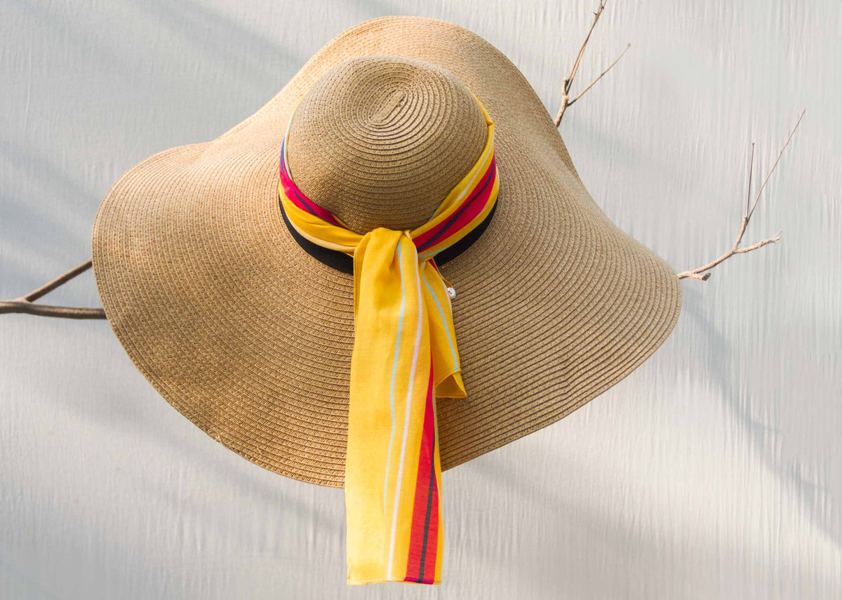 Sunshine Scarf tied around the band of a straw hat.