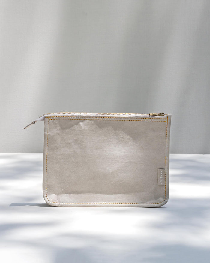 Grey Paper Pouch with a gold zip along the top.