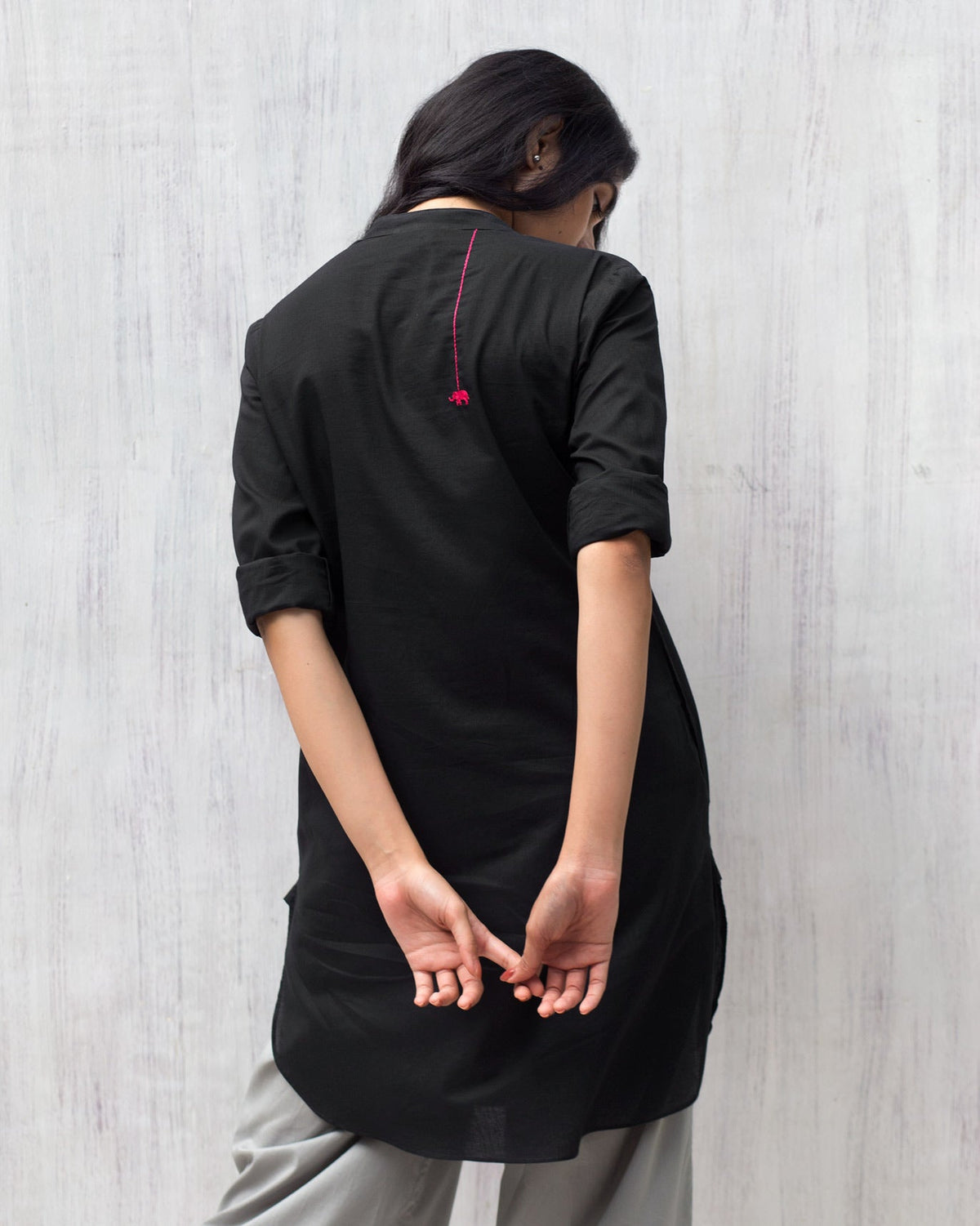 Back of a black Basic Mid Length Kurta with a red elephant embroidery.