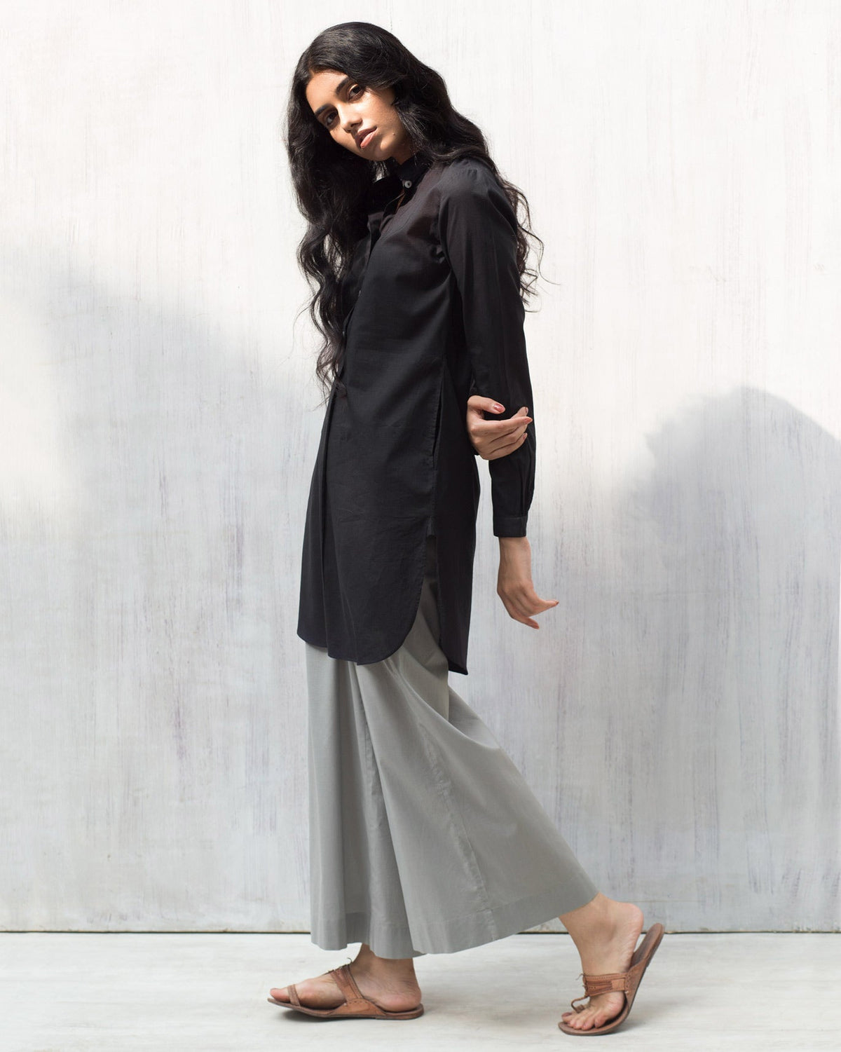 Side view of a black Basic Mid Length Kurta worn by a person.