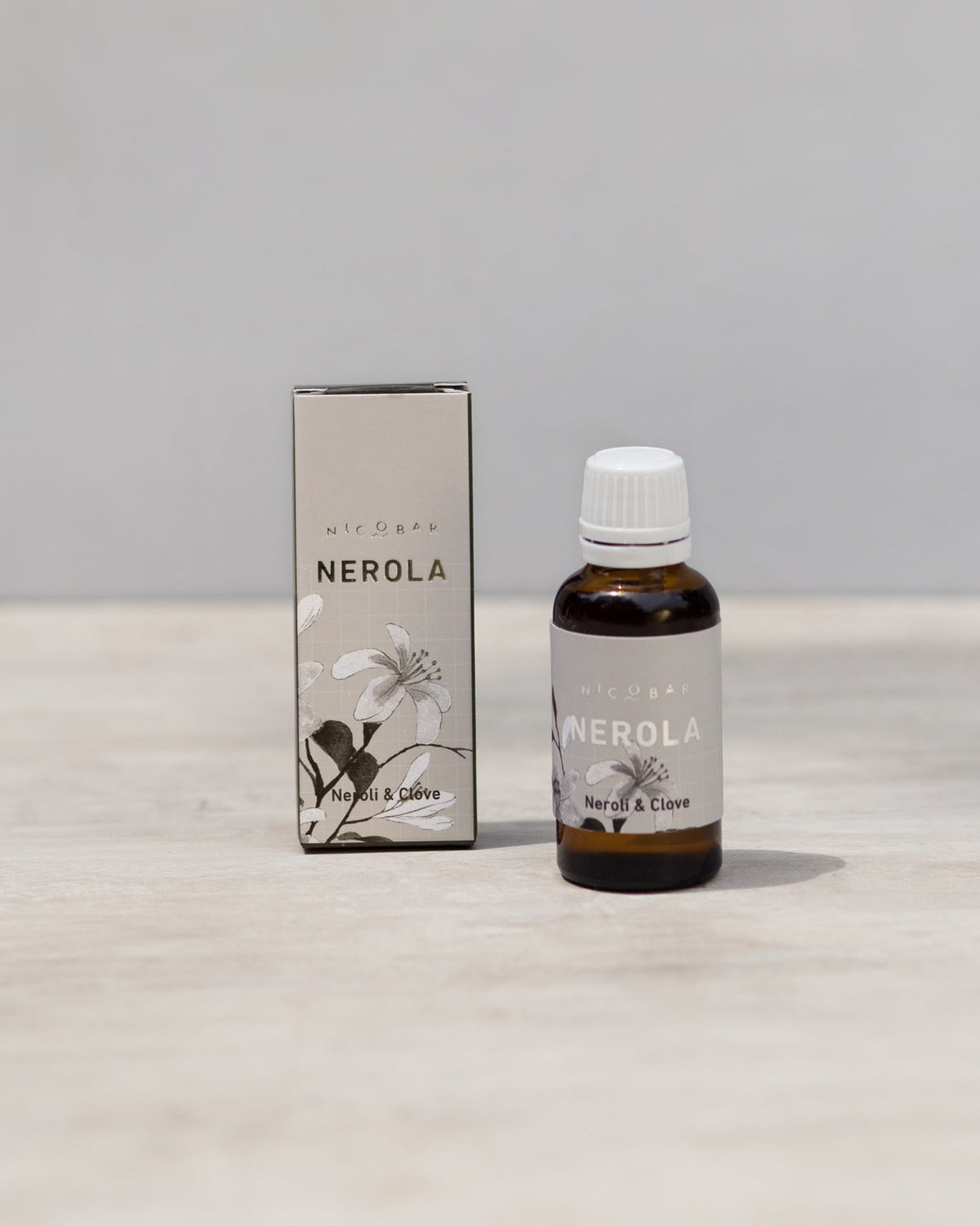 Nerola Fragrance Vial beside its box, with a Neroli & Clove label.