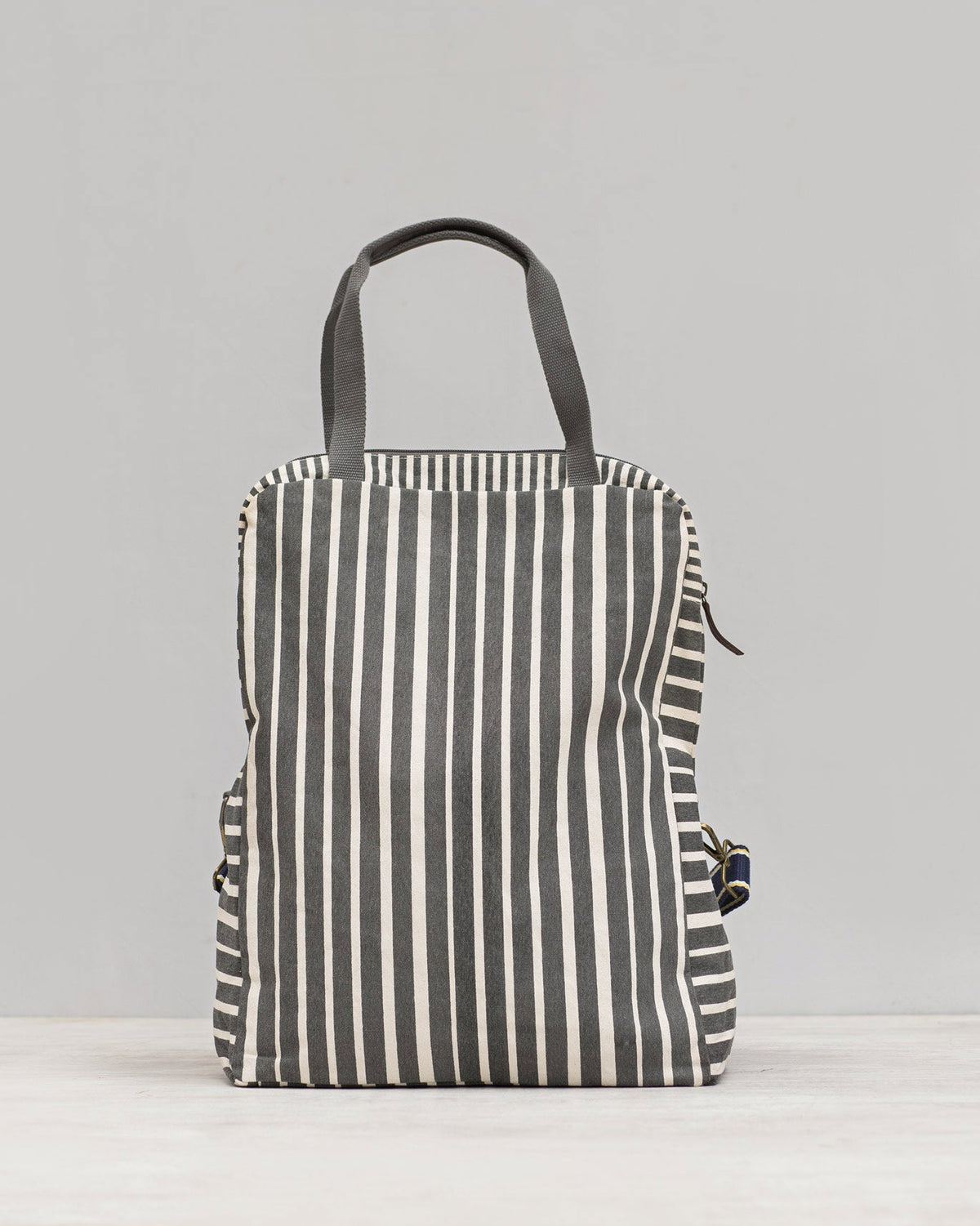 Back of a Noto Artist's bag in charcoal and cream stripes.