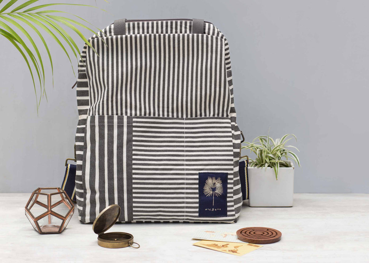Noto Artist's bag on a table, showing its patchwork stripe pocket.