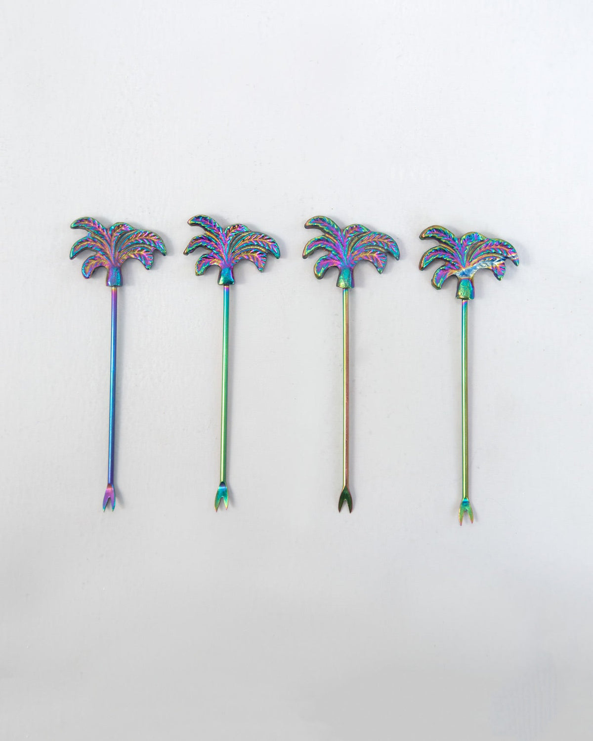 Coco Fruit Pick With Stand shown as four palm-tree picks in a row with fork ends.