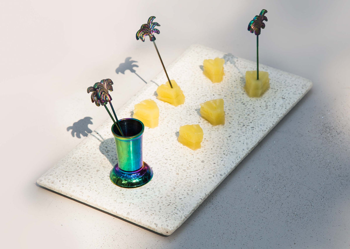 Coco Fruit Pick With Stand on a tray, with its picks in yellow fruit cubes.