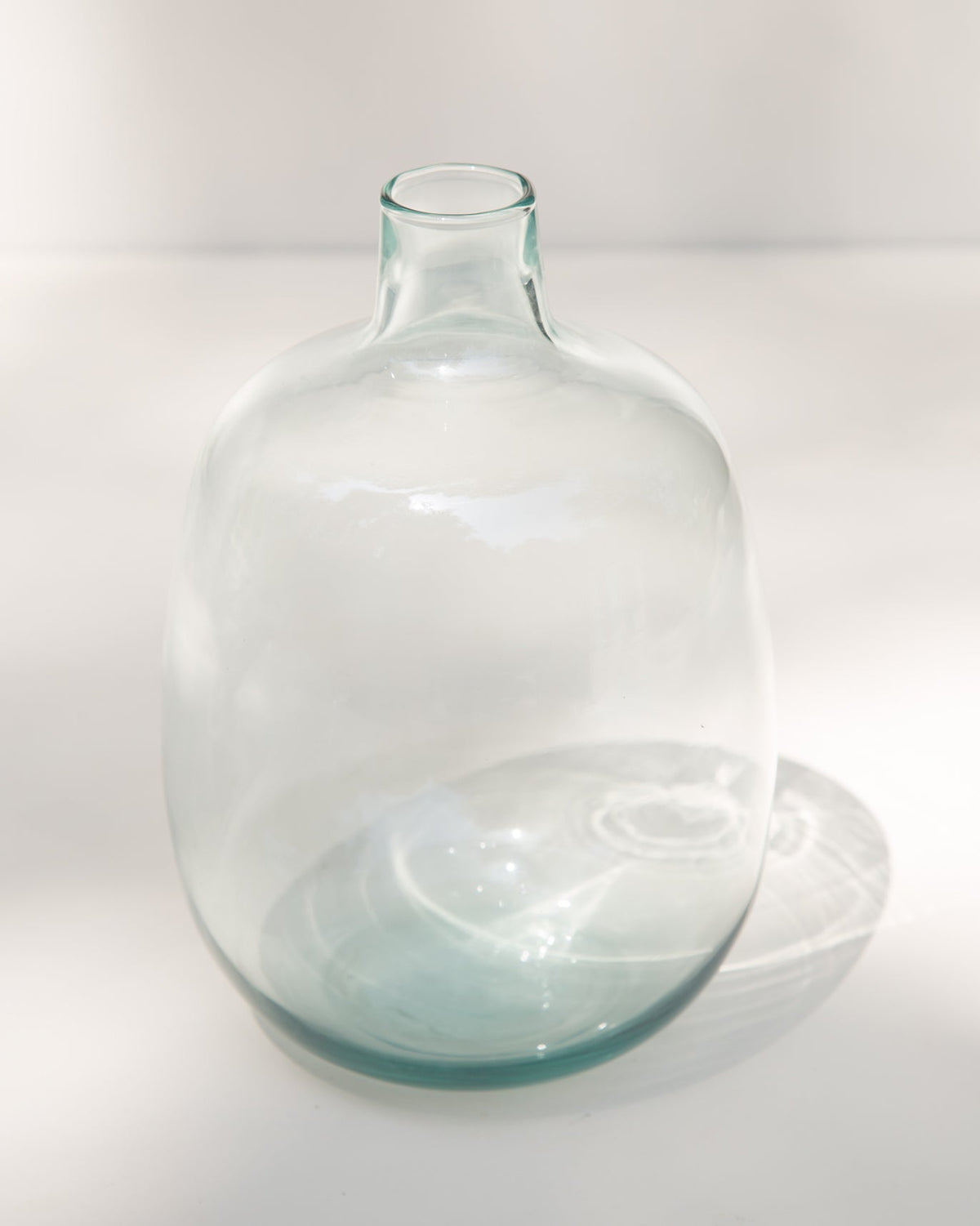 Three-quarter view of the Aura Glass Vase showing its rounded base.