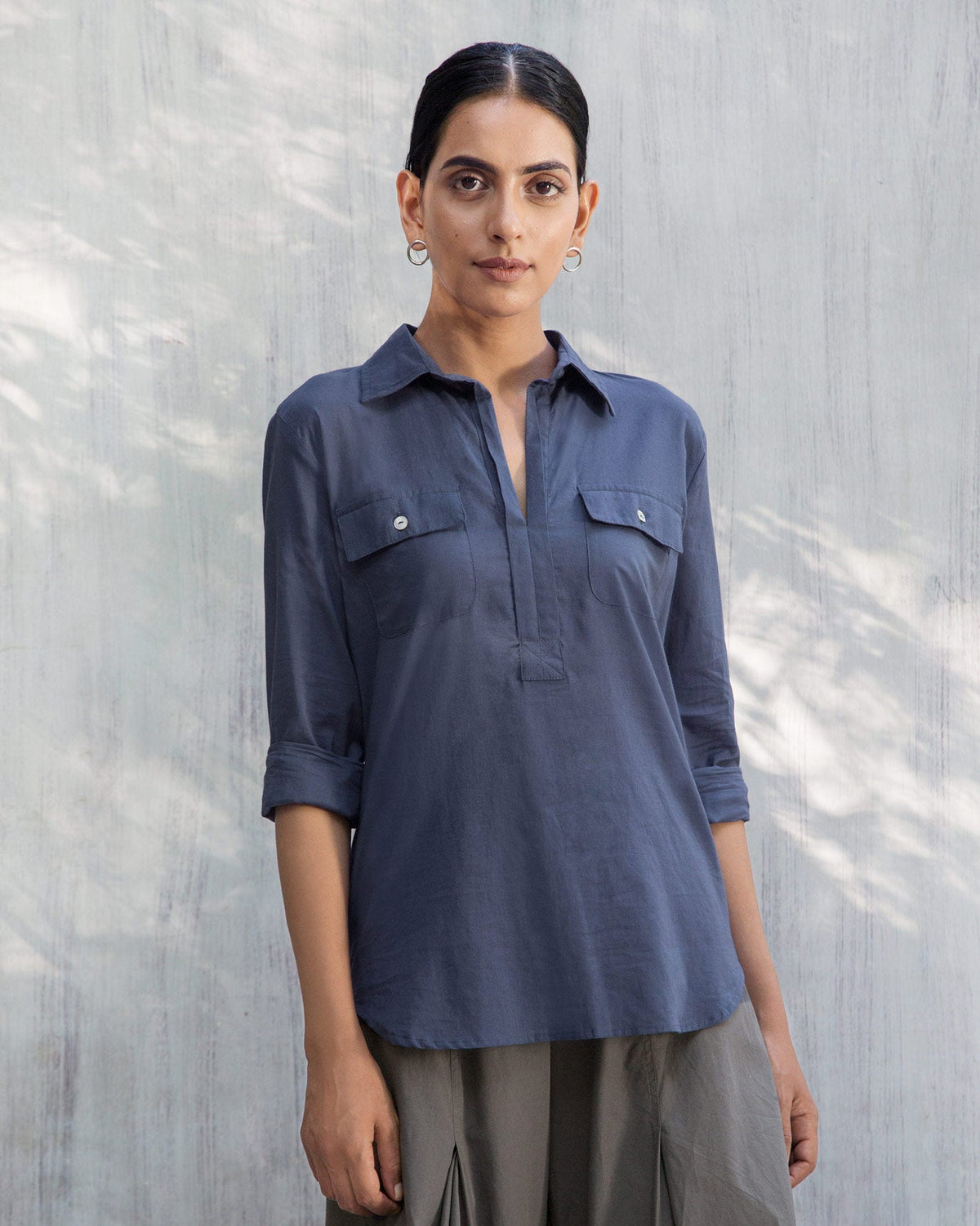 Person wearing an indigo Open Collar Top with chest pockets.