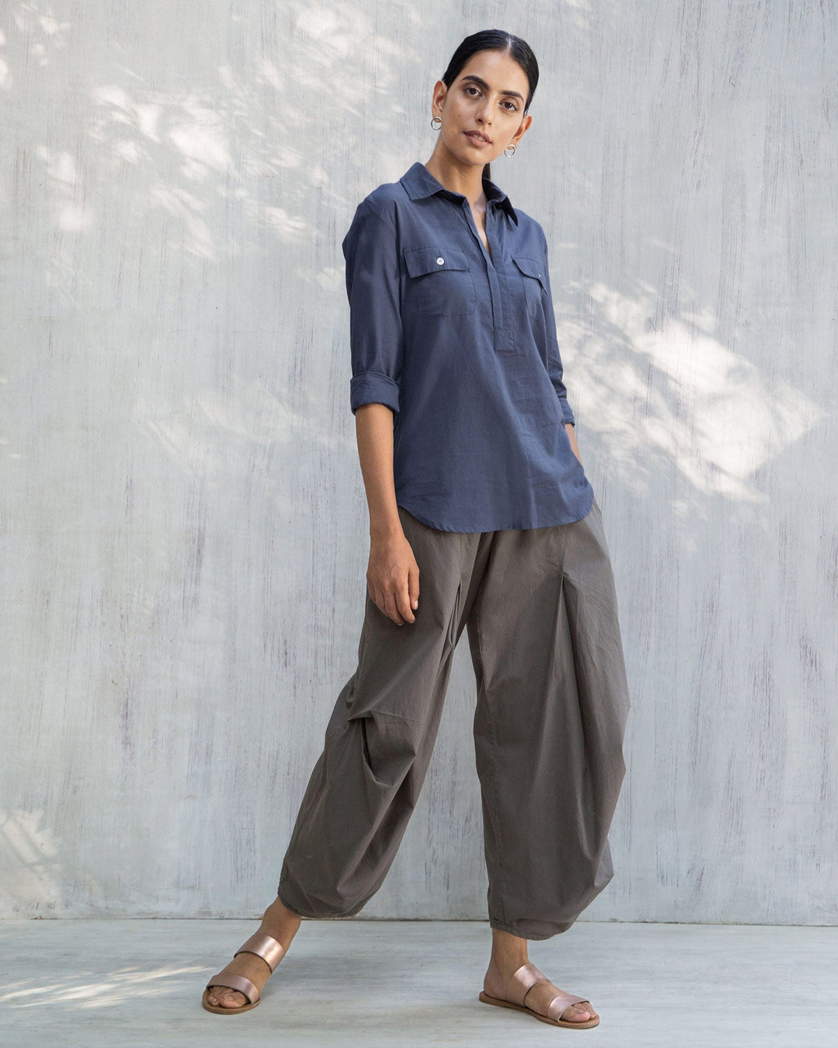 Full-length view of an indigo Open Collar Top with rolled sleeves.