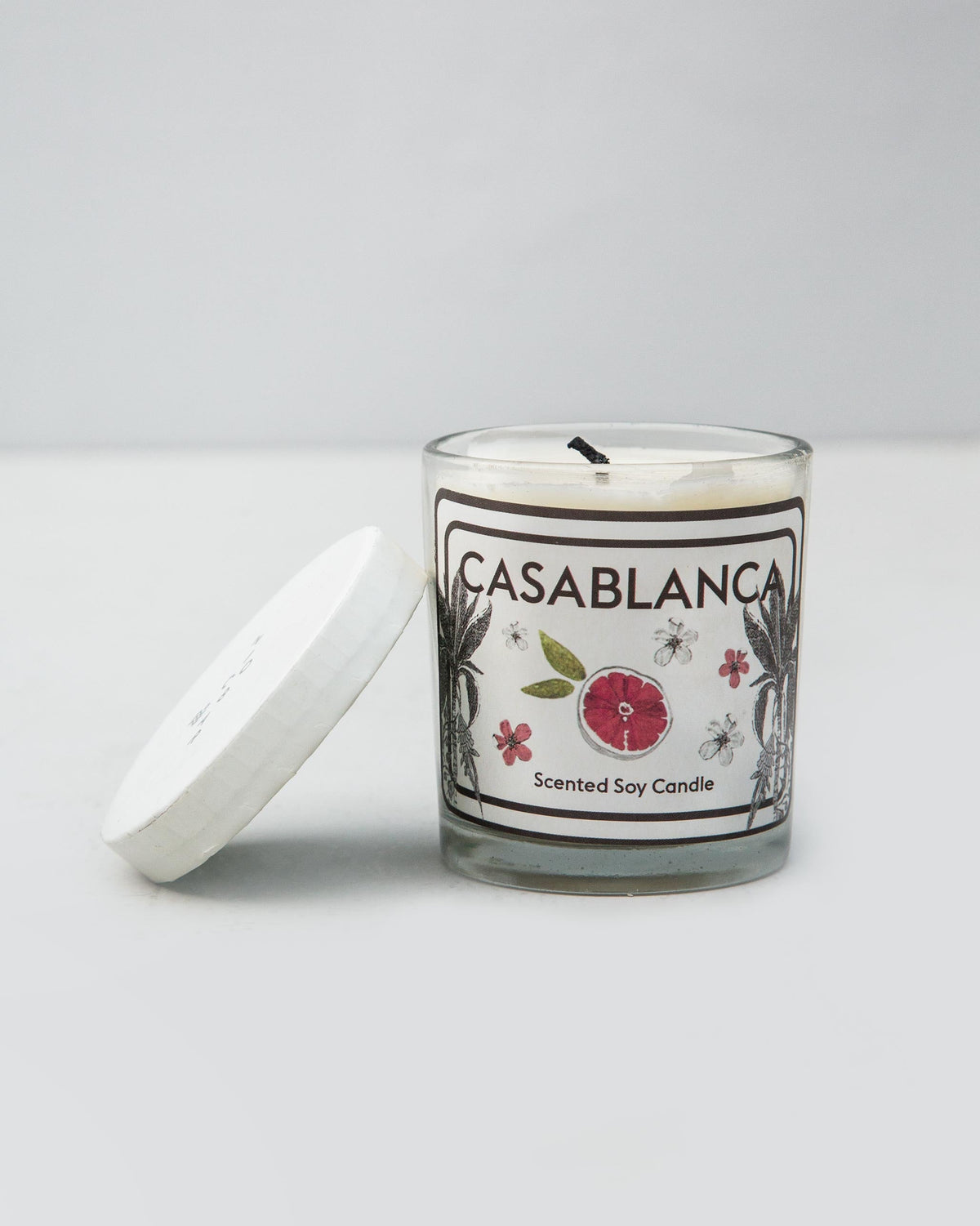 Casablanca Jar Candle with its white lid off, resting beside the jar.