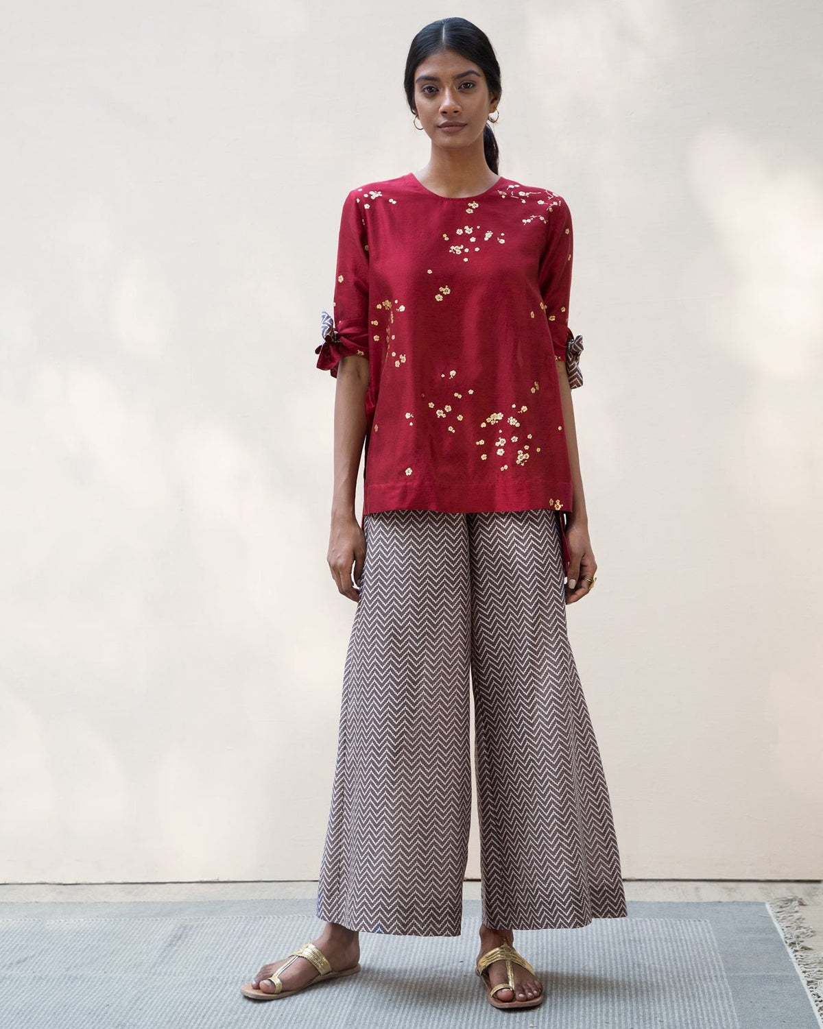 Full-length front view of a red Side High Slit Top worn by a person.
