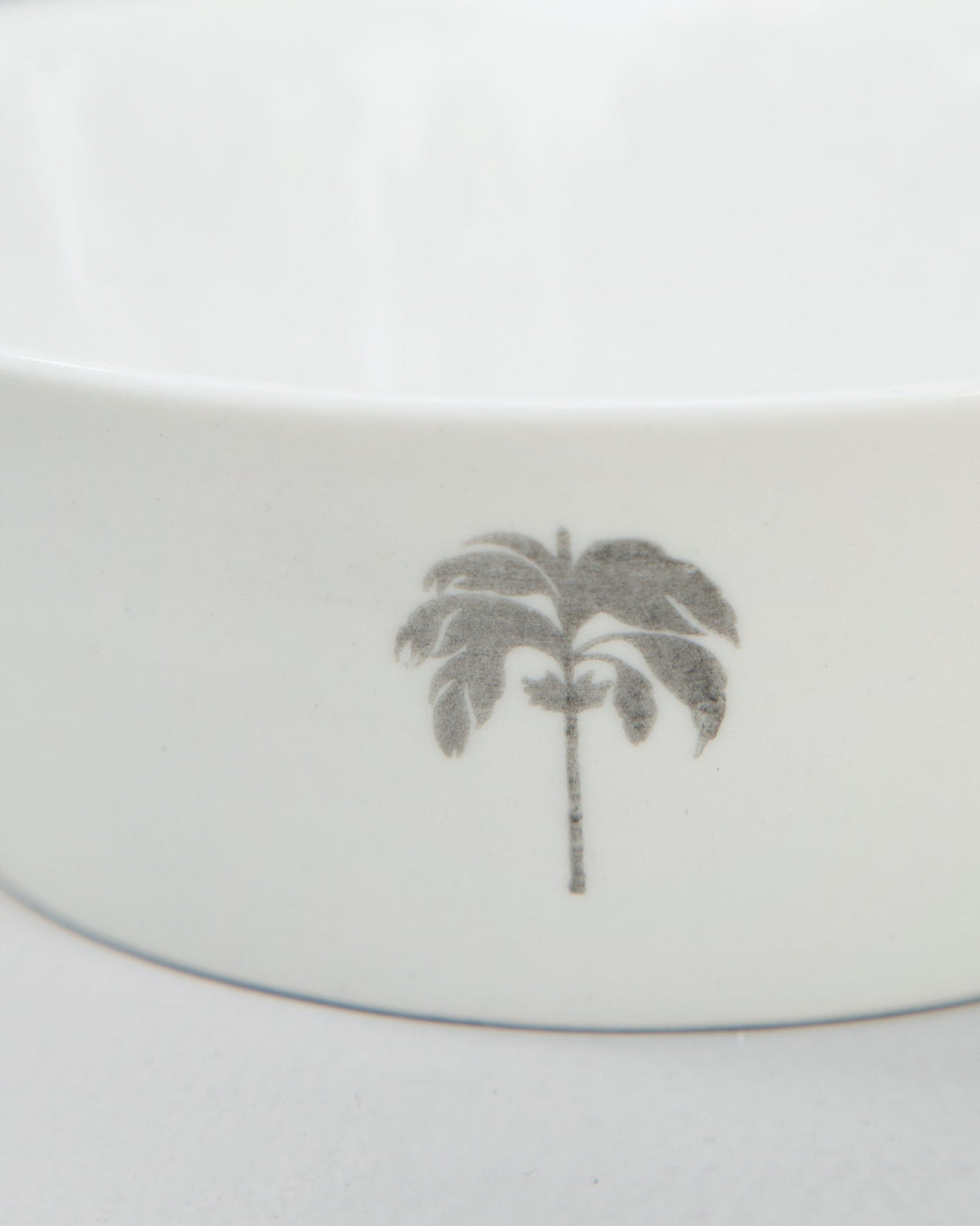 Close-up of a Colombo Cereal bowl showing its grey palm motif.