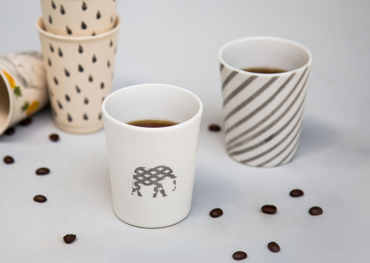 Colombo Kulhar (Set of 2) filled with coffee, one with an elephant motif.