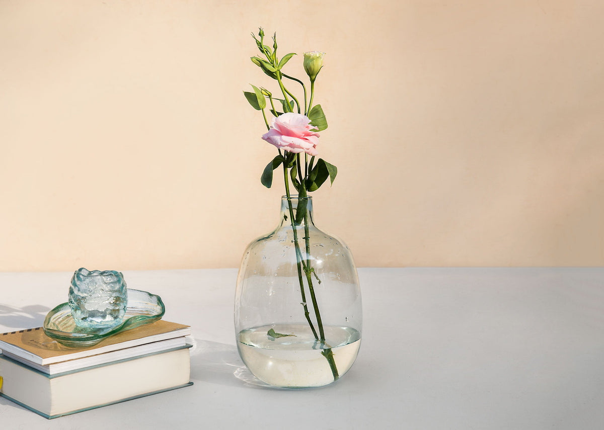 Aura Glass Vase holding a pink rose in water.