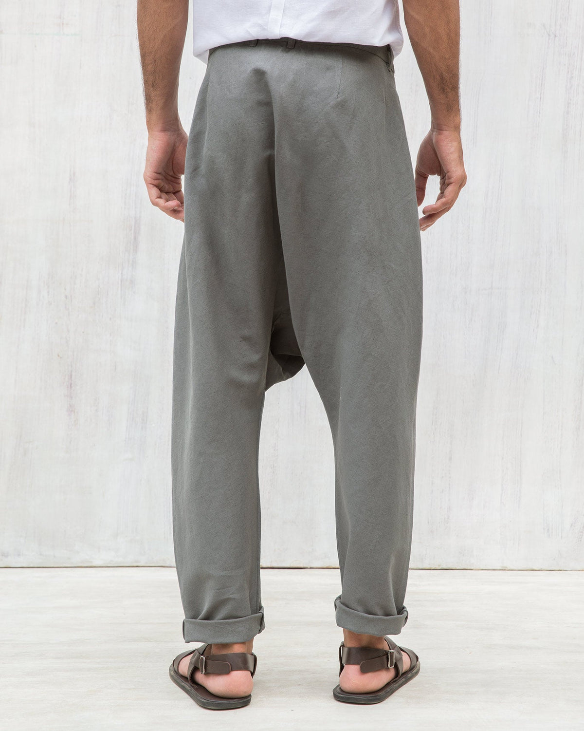 Back of Slouchy Pants with turned-up cuffs worn by a person.