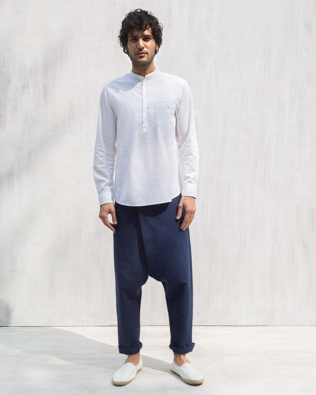 Blue Slouchy pants worn full length with a wrap-front fit.