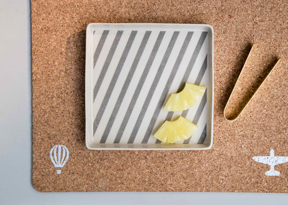 Colombo Cookie tray with Tongs holding yellow fruit cubes, with tongs beside it.