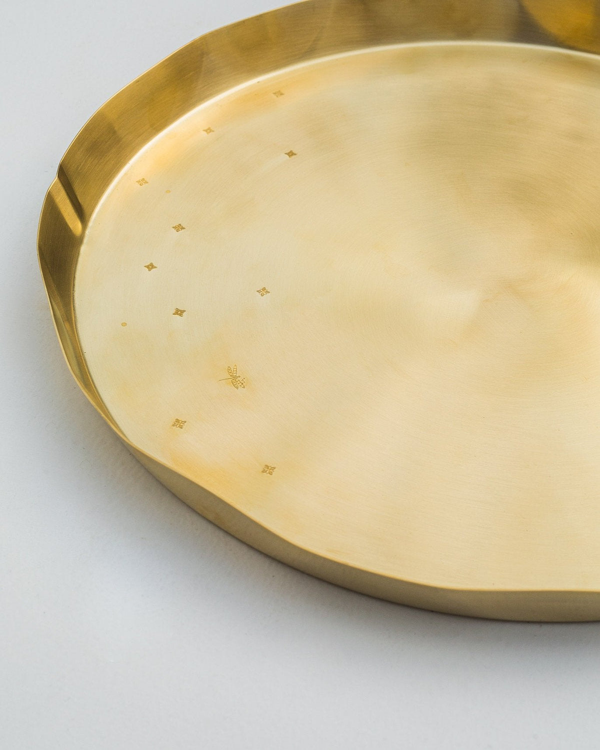 Close-up of Lotus Leaf Brass Thali showing its scalloped rim and engraved motifs.