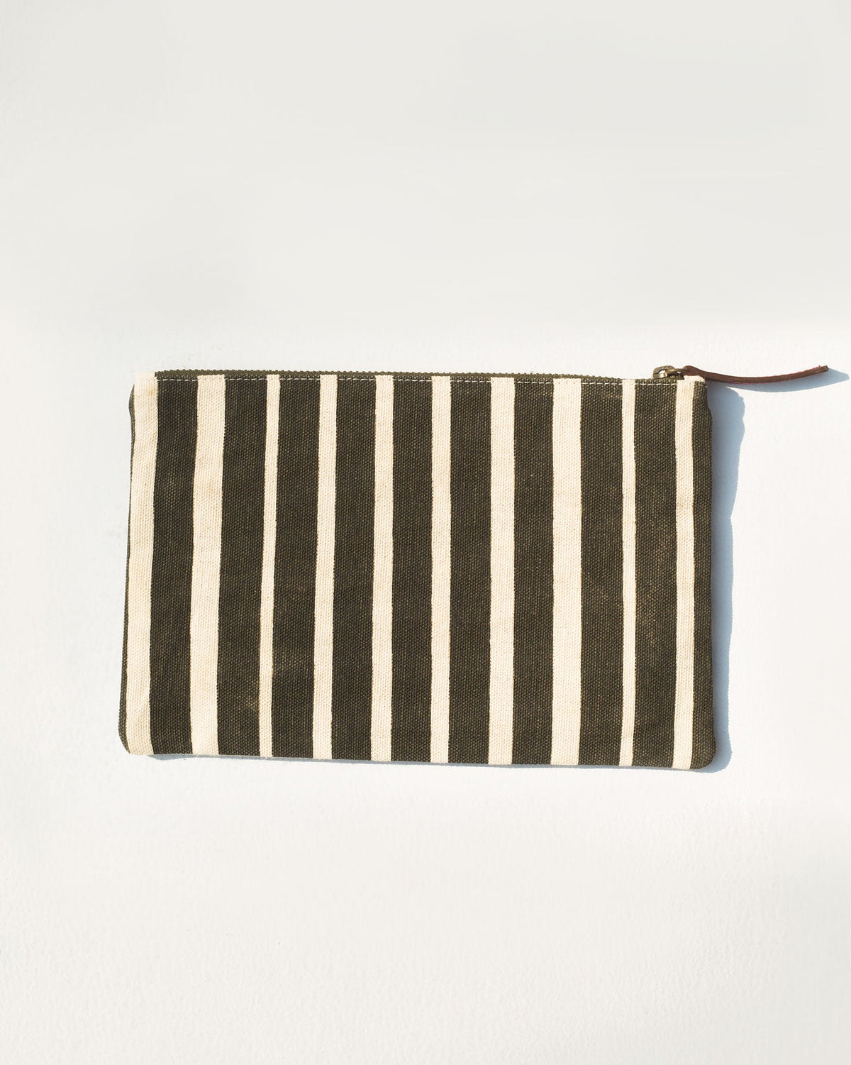 Back of Alphabet Y Pouch in olive and cream stripes with a tan zip pull.
