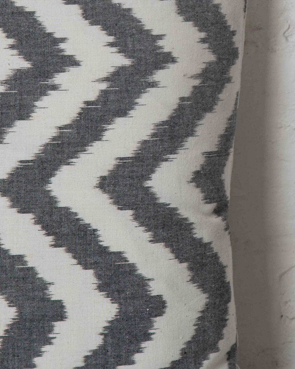 Close-up of Ikat Chevron Pillow Cover showing its grey and white chevron pattern.