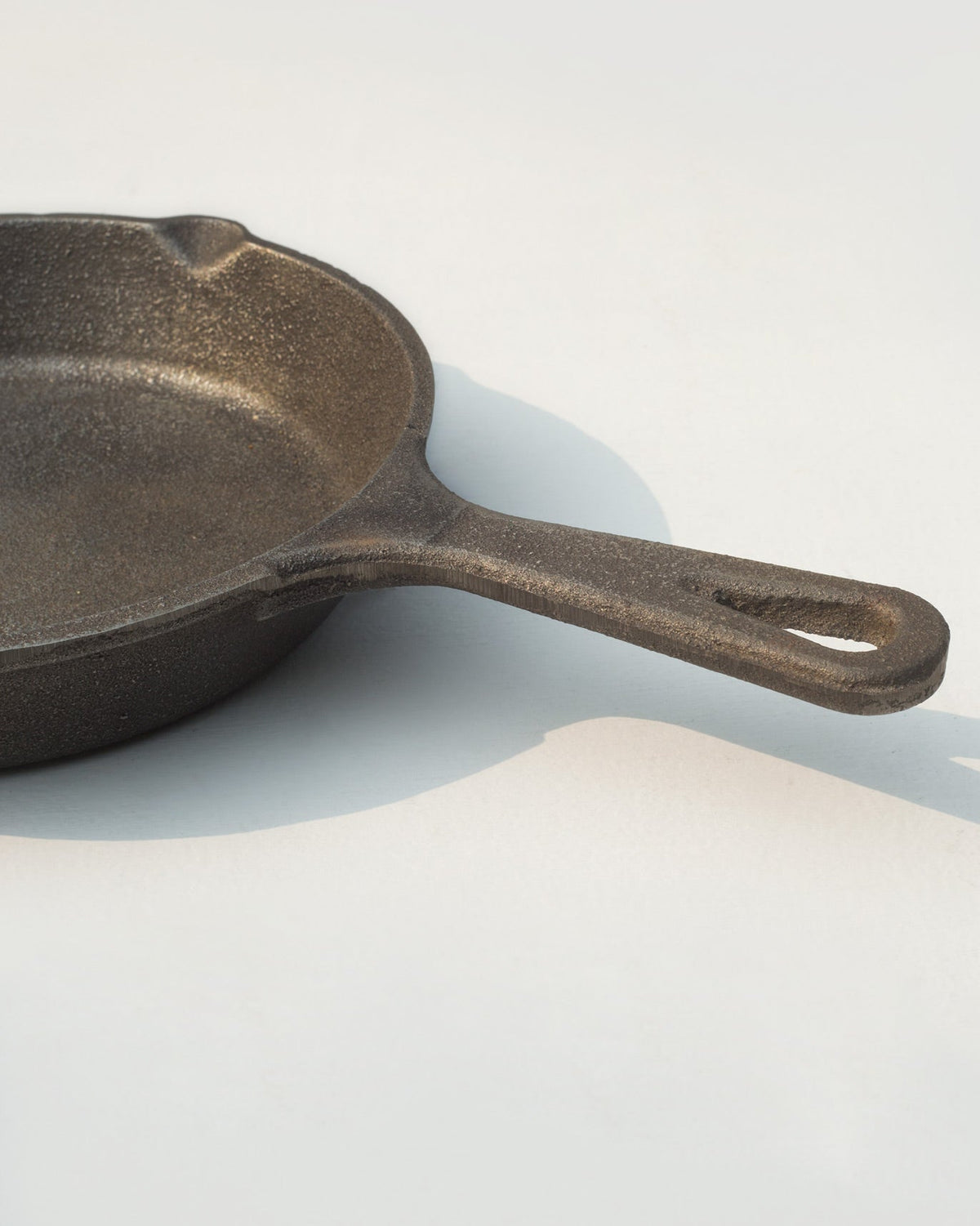 Close-up of the Cast Iron Skillet long handle, with a hole at its end.