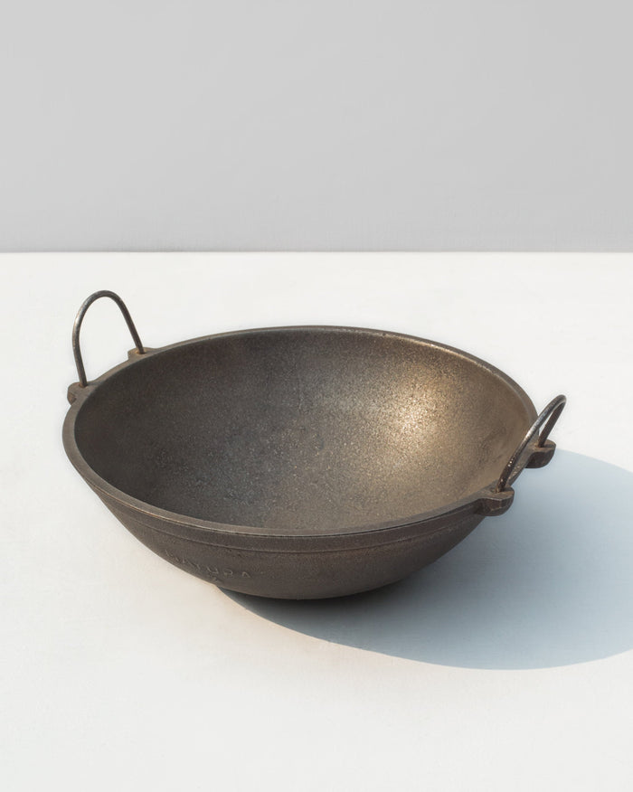 Cast Iron Kadai with two loop handles, seen at a three-quarter angle.